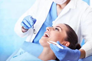 Dentist examining patient’s teeth during checkup, dentist.