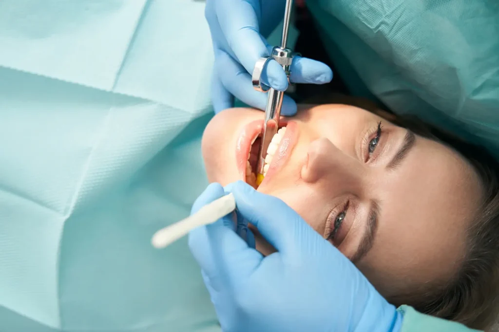Patient receiving local anesthesia during procedure, dentist.