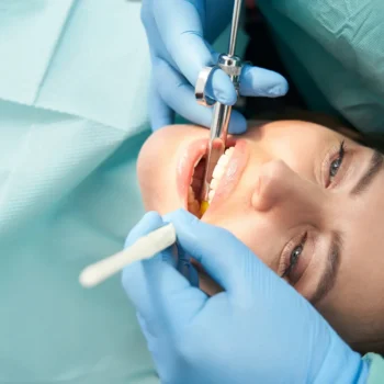 Patient receiving local anesthesia during procedure, dentist.