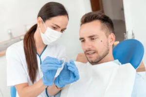 Dentist in La Vergne, TN showing Invisalign aligner to patient